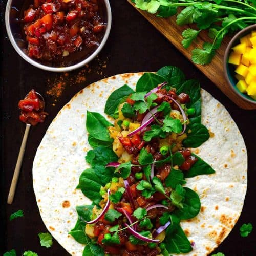 These samosa wraps are super easy to put together with spiced potatoes and peas, crisp greens, spicy red onion and a simple homemade mango chutney. Make these samosa wraps ahead and freeze them for a quick lunch (or dinner) throughout the week.