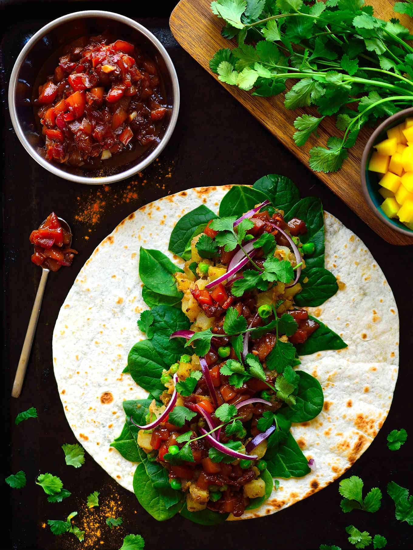 These samosa wraps are super easy to put together with spiced potatoes and peas, crisp greens, spicy red onion and a simple homemade mango chutney. Make these samosa wraps ahead and freeze them for a quick lunch (or dinner) throughout the week.