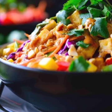 This Thai Buddha bowl is quick and easy to put together with heaps of fresh vegetables and crispy fried tofu served over coconut rice and topped off with a simple Thai peanut sauce with spicy red curry. Great for a weeknight dinner, these bowls come together in just 15 minutes!