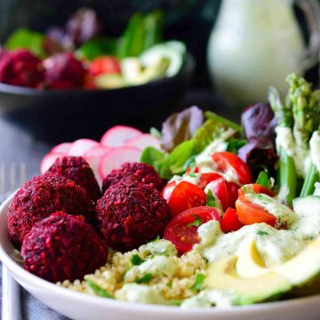 You’ll get a whole, balanced and filling meal in just one dish with this baked beet falafel vegan quinoa bowl with horseradish dill sauce. Beet falafel is a great twist on traditional falafel with the same great taste and an extra dose of veggies. They’re baked rather than fried for a healthier and oil-free recipe and served on a bed of quinoa and a mix of delicious raw and lightly cooked vegetables.