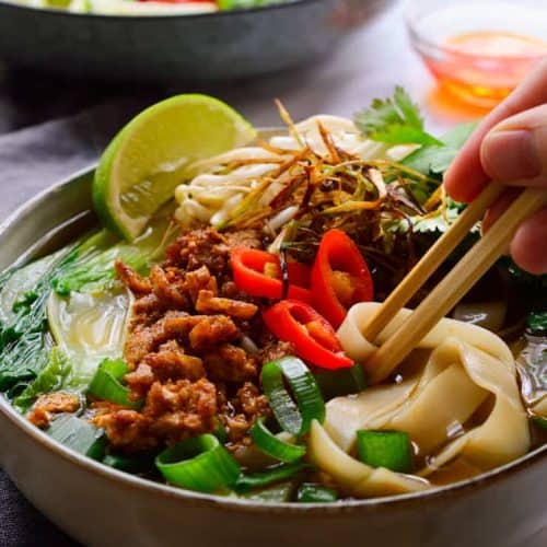 This vegan pho recipe will appease all your cravings for a delicious, intensely flavoured vegetarian pho. Thick slurpy rice noodles in a deliciously spiced umami broth and topped with smoky crumbled tofu, sweet frizzled onion, fresh herbs and sprouts. A bowl of soup so good you won’t believe that this vegan pho is made 100% from scratch in less than one hour!