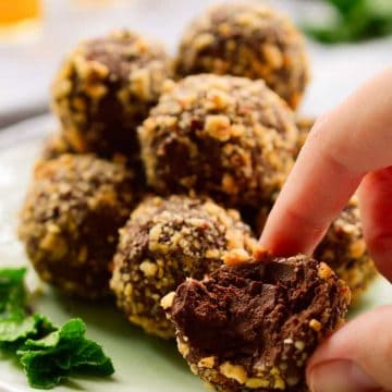 Vegan mint chocolate truffles rolled in crushed hazelnuts.