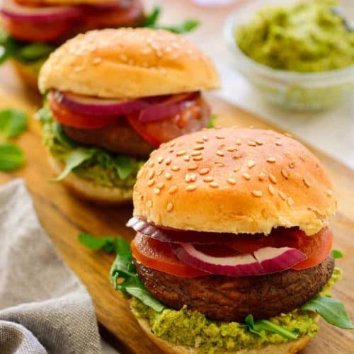 Three vegetarian sliders on a try with mint-pea pesto in a bowl.