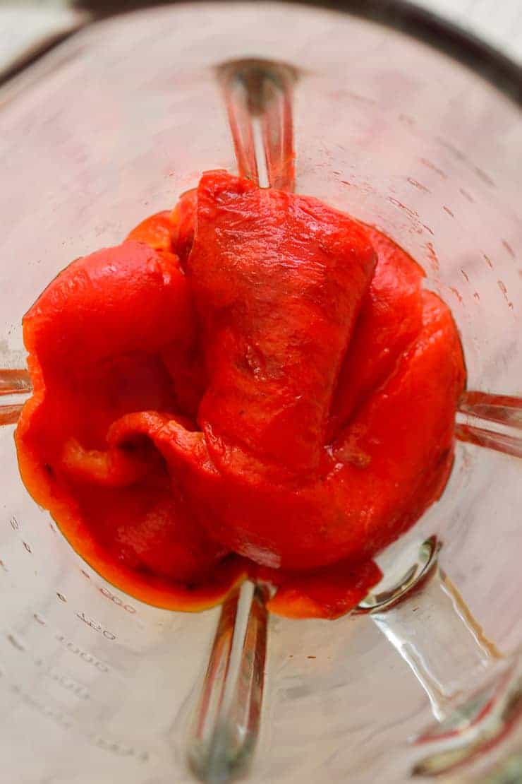 Skinned roasted red peppers in a blender.