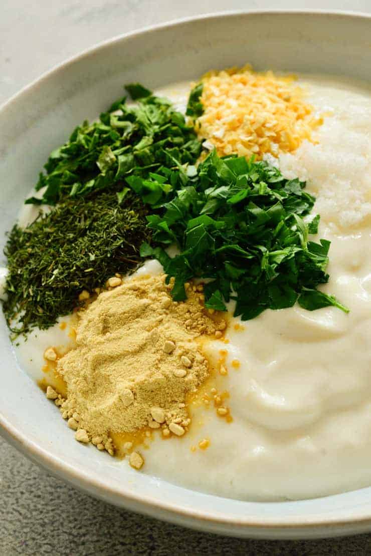 All the ingredients for vegan ranch dip in a bowl but not mixed together.