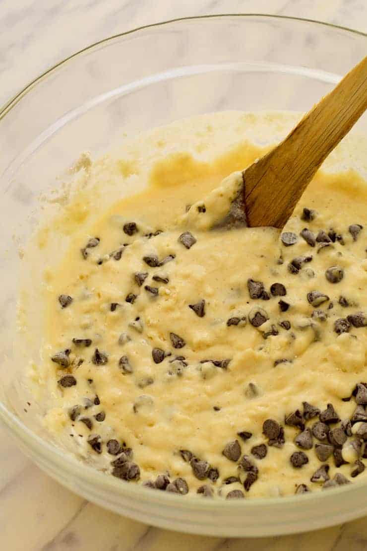 A bowl of combined pancake batter with chocolate chips.