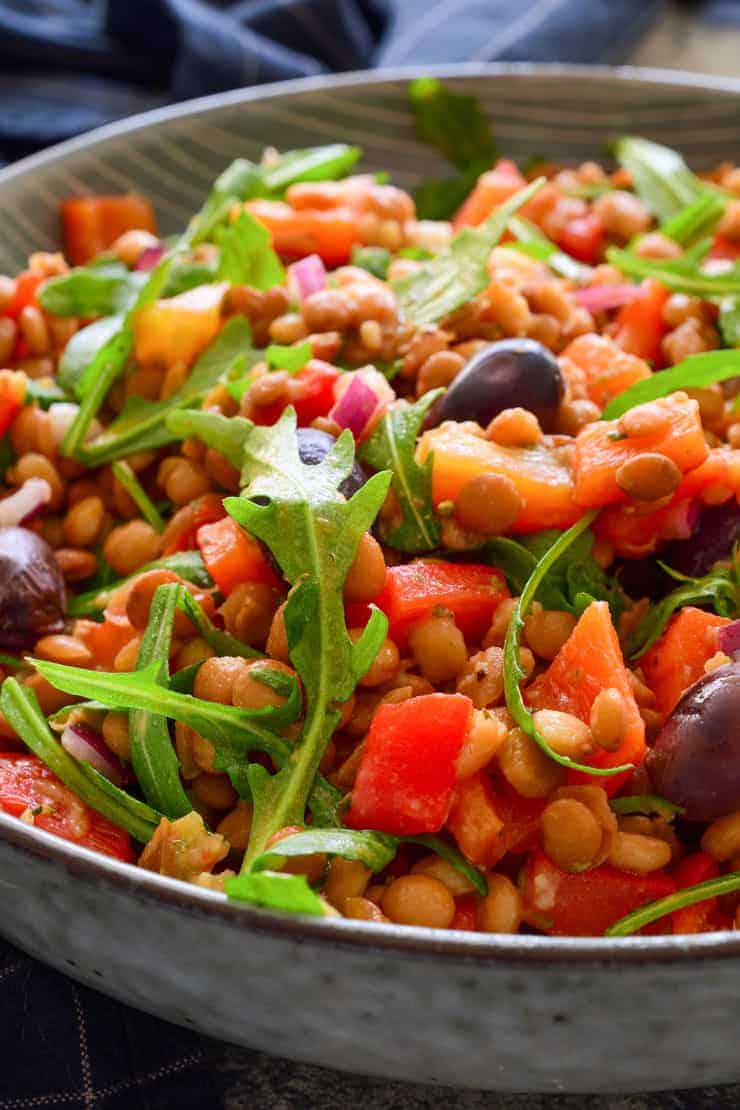 A close-up photo of the vegan lentil salad in a blue bowl.