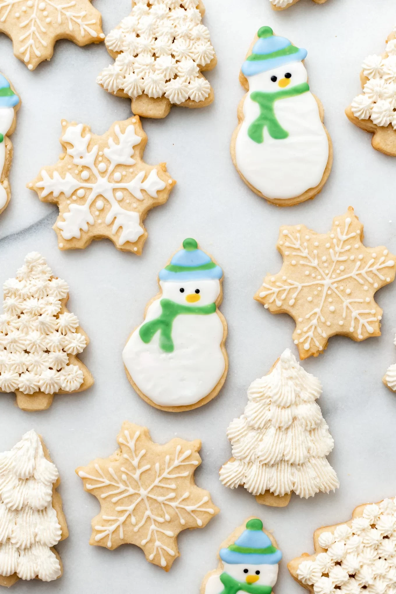 Vegan sugar cookies in snowman, Christmas tree and snowflake shapes.
