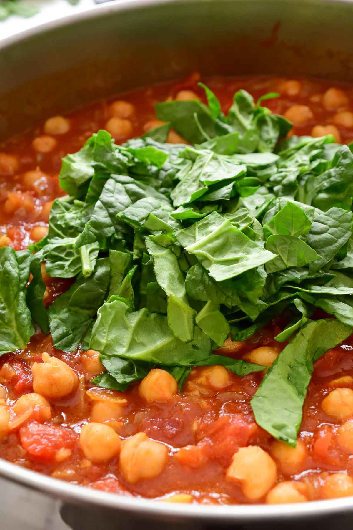 A pile of fresh spinach in the pan.