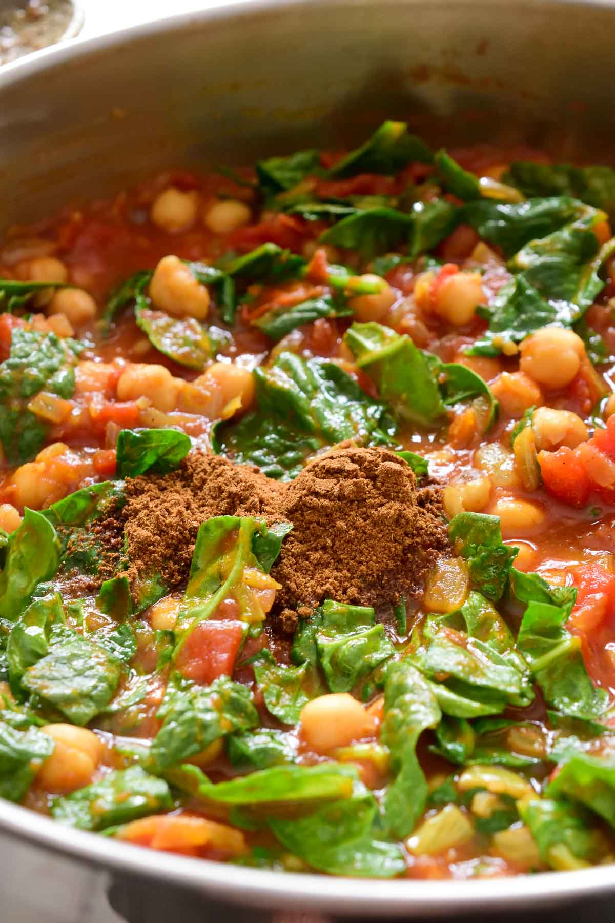 Garam masala in the pan of chickpea curry.