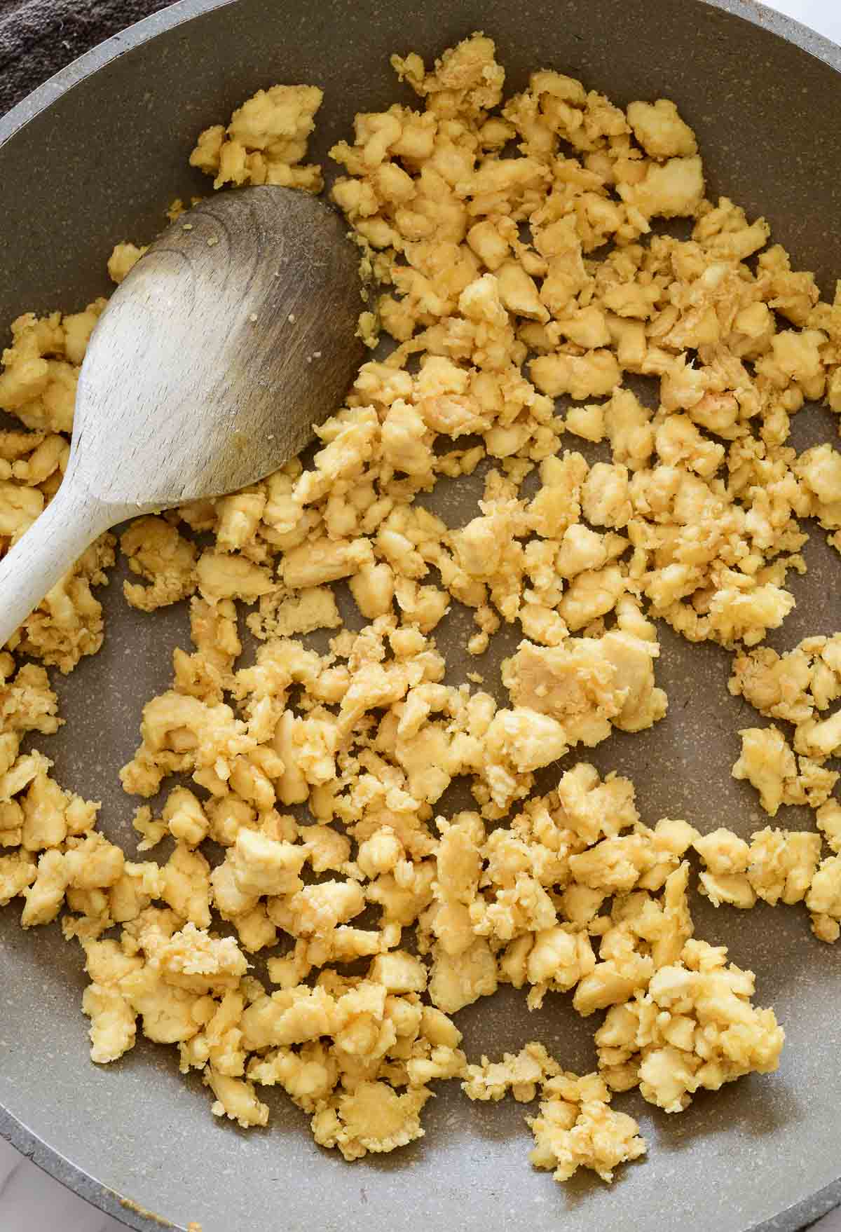 A grey pan filled with crispy fried tofu.