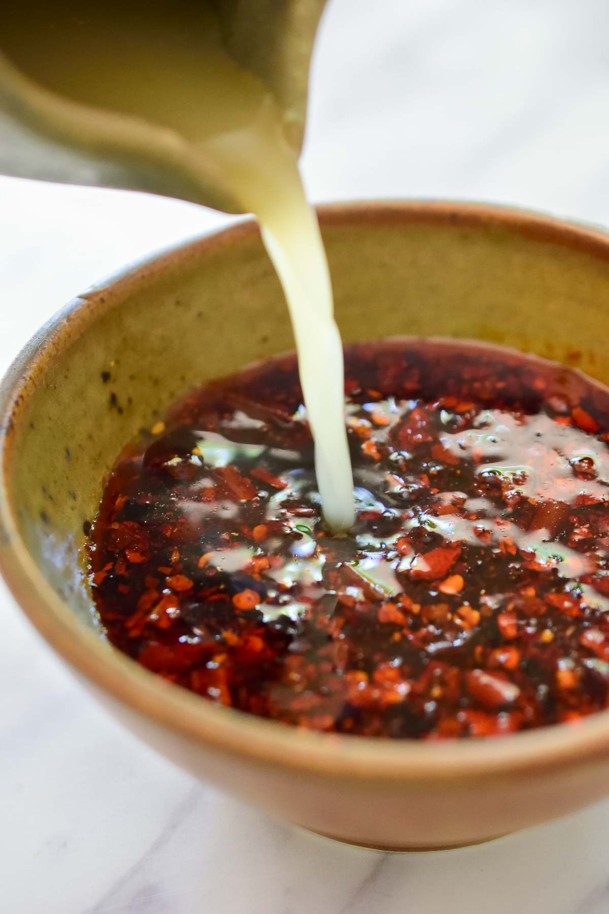 A small ceramic bowl of vegan stir fry sauce.